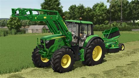 zdjęcie ładowacza John Deere serii M na ciągniku w ciasnym pomieszczeniu
