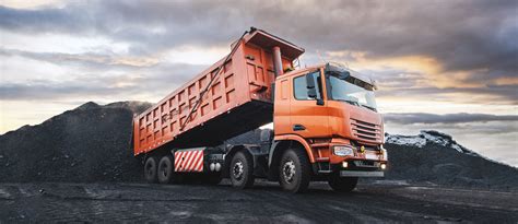 Thematic photo of a MAN semi-truck with a tipper trailer on a construction site
