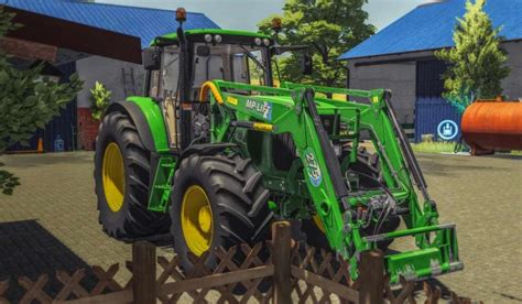 Tematyczne zdjęcie ładowacza czołowego pracującego z ciągnikiem John Deere w gospodarstwie
