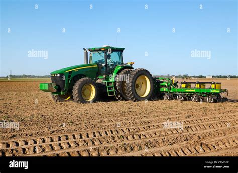 Thematic photo of a John Deere tractor working in a field