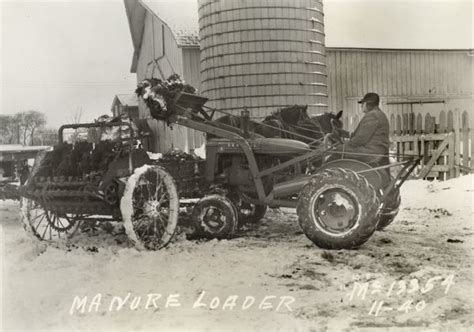 Historical photo of a Cyklop loader in action on a farm, loading manure or hay