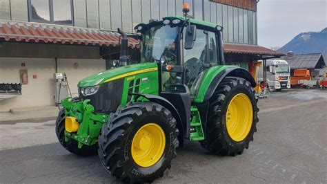 Thematic photo of John Deere 6120M tractor working in the field
