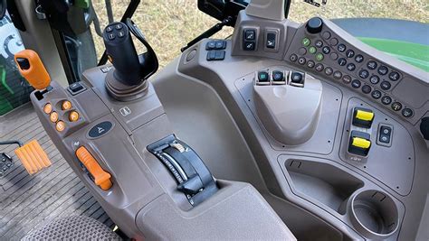 Interior view of John Deere 6120M cabin with focus on controls