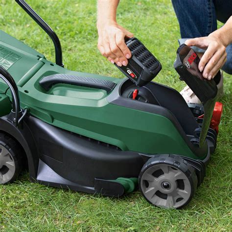 Thematic photo of a person choosing a battery for a lawnmower