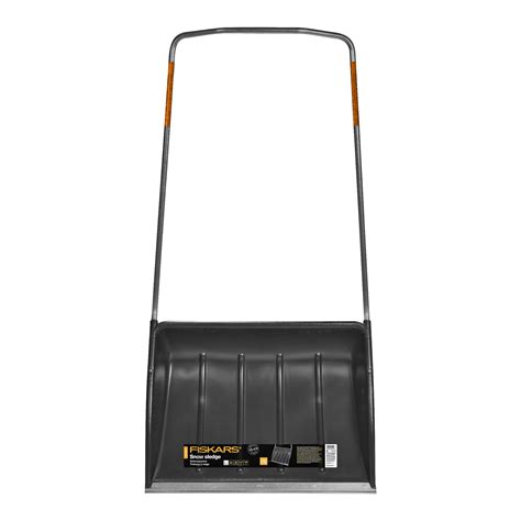 Zdjęcie przedstawiające pług śnieżny Fiskars SnowXpert 72 cm w zimowej scenerii na podjeździe