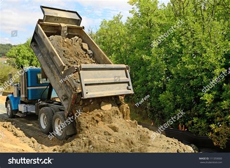Thematic photo of a truck dumping soil on a construction site or garden