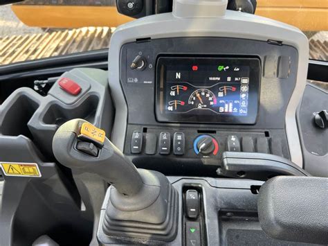 Infographic showing joystick control scheme for a backhoe loader