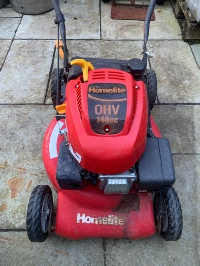 Thematic photo of a Homelite petrol brushcutter/lawnmower in a garden setting