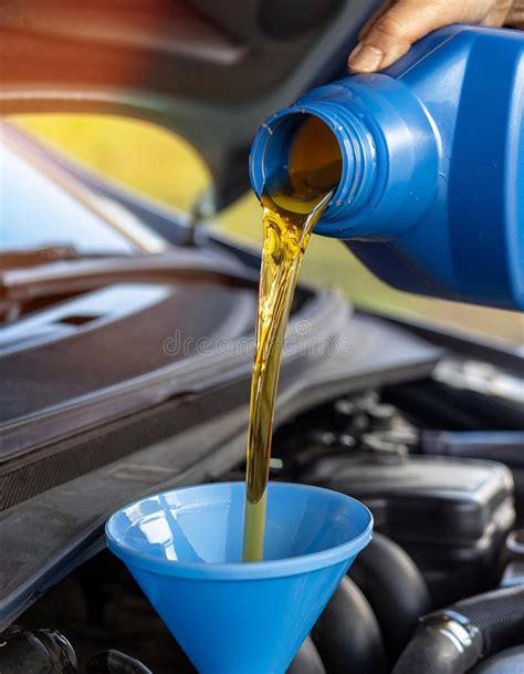 Thematic photo of a person pouring oil into a two-stroke engine.