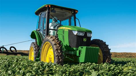Thematic photo of a John Deere 6105MC tractor working in a field