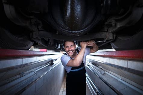 Mechanik pracuje pod ciężarówką, schemat bezpieczeństwa
