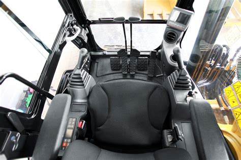 Photo of the interior of an excavator cabin with joysticks