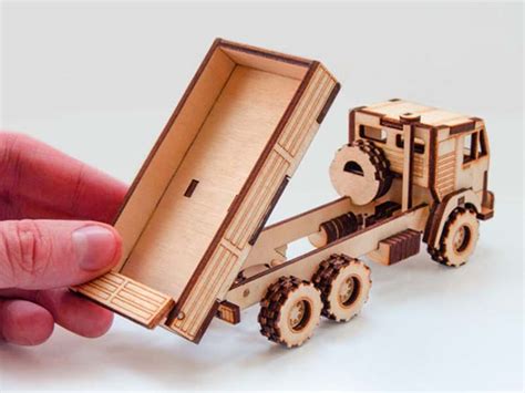 Thematic photo of a wooden 3D puzzle in the form of a dump truck in the process of assembly