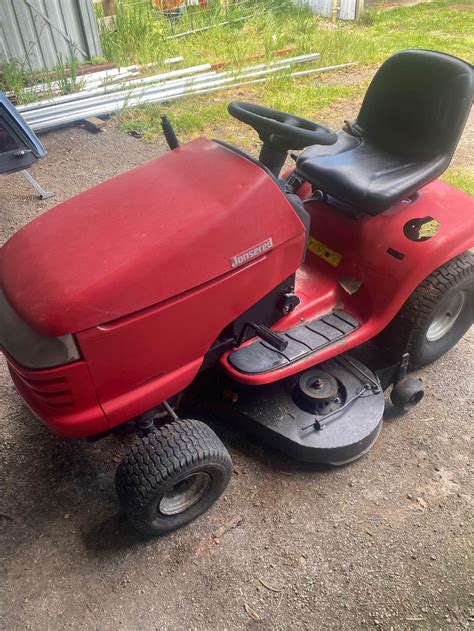 Thematic photo of a Jonsered LR 13 ride-on mower with a grass catcher