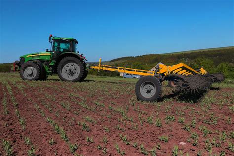 Thematic photo of an active rotary harrow working in a field