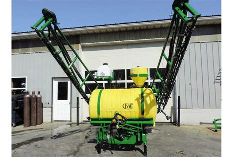 Thematic photo of a suspended sprayer attached to a tractor in a field.