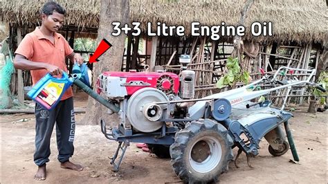 Thematic photo of a person changing oil in a tiller engine.