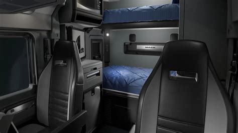 Interior of a modern MAN truck cab showing the dashboard and sleeping area