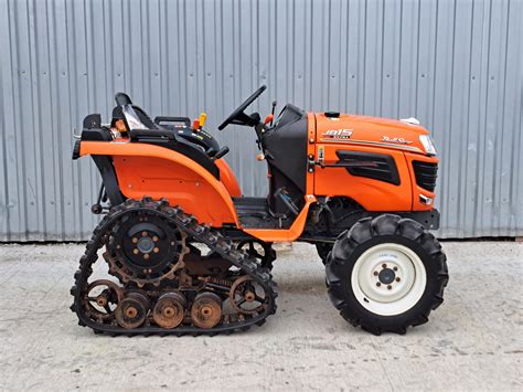 Ilustracja przedstawiająca dwa minitraktory z silnikami Kubota i Iseki, symbolizująca porównanie.