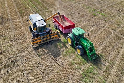 Thematic photo of a modern farm with various agricultural machinery in the field