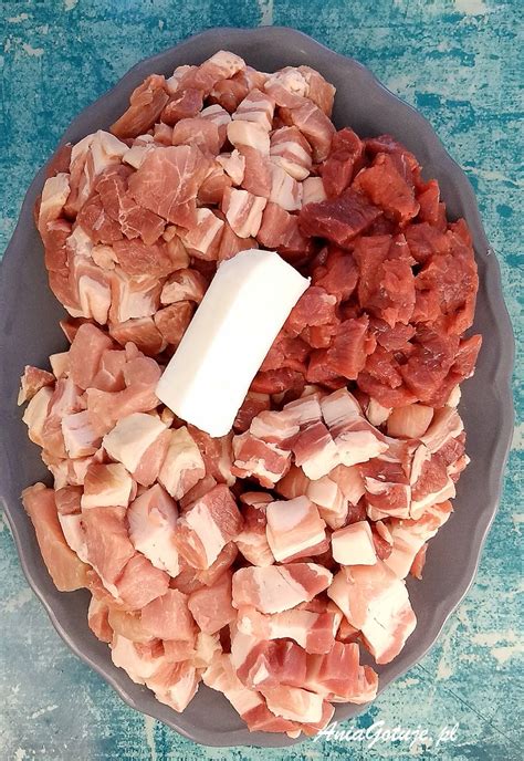 Różne rodzaje mięs i wędlin pokrojone w kostkę, przygotowane do bigosu