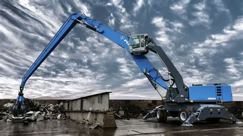 The Terex Fuchs MHL 320 material handler in action, lifting scrap metal