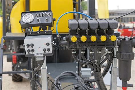 Thematic photo of an agricultural sprayer with a visible control panel and manifold
