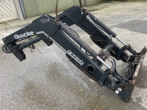 Thematic photo of Quicke Q98 front loader mounted on a large tractor during fieldwork