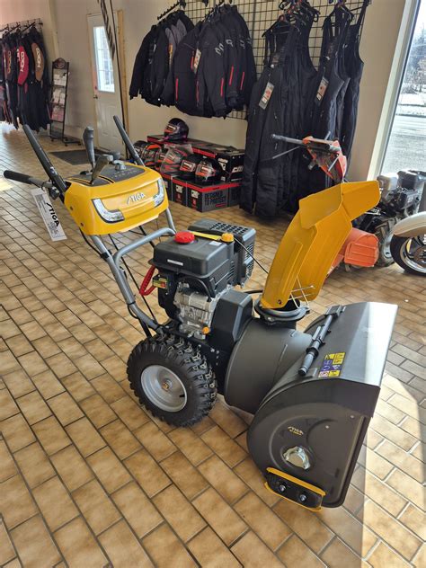 A Stiga petrol-powered snowblower clearing a large area, showcasing its robust design.