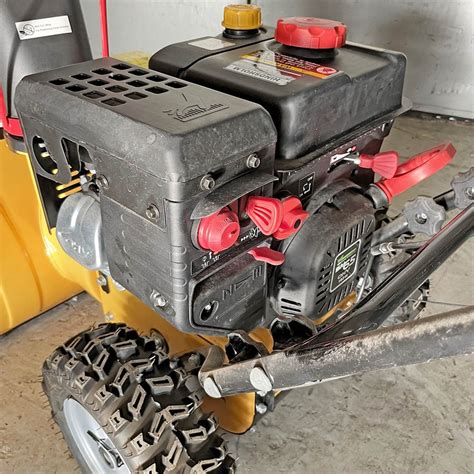 A detailed view of the powerful engine and controls of the STIGA Snow Power snowblower.
