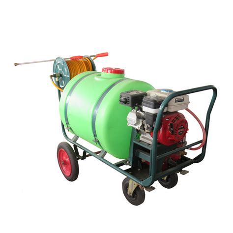 Thematic photo of a 100L wheelbarrow sprayer with a small tractor in the background
