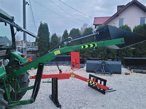 Tematyczne zdjęcie ładowacza na tył ciągnika w akcji na polu