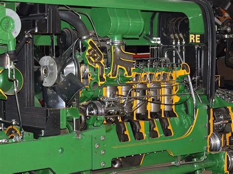 Engine compartment of a John Deere 5M tractor, highlighting the PowerTech E engine and DPF system.