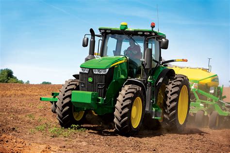 A John Deere 7R series tractor on a test stand, highlighting its powerful engine and advanced features.