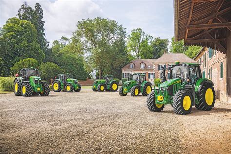 A lineup of John Deere 6M series tractors, showcasing the variety of models and frame sizes.
